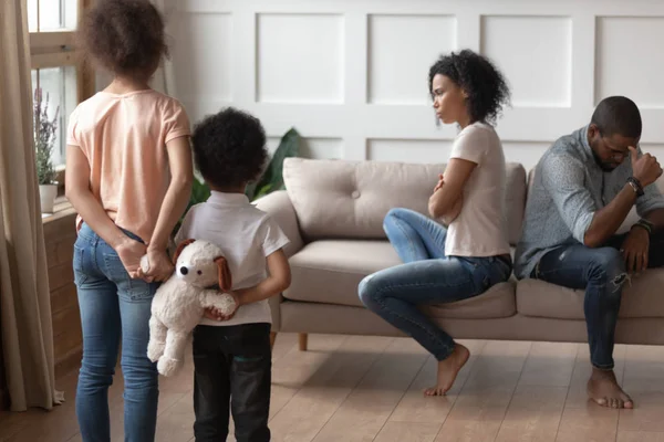 Rear view sad african kids looking at parents in quarrel — Stock Photo, Image