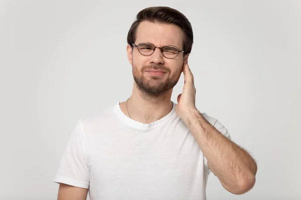 Unhappy Caucasian man touch ear suffering from noisy sound — Stock Photo, Image