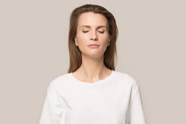 Mujer tranquila y consciente con los ojos cerrados respirando profundo, sin estrés —  Fotos de Stock