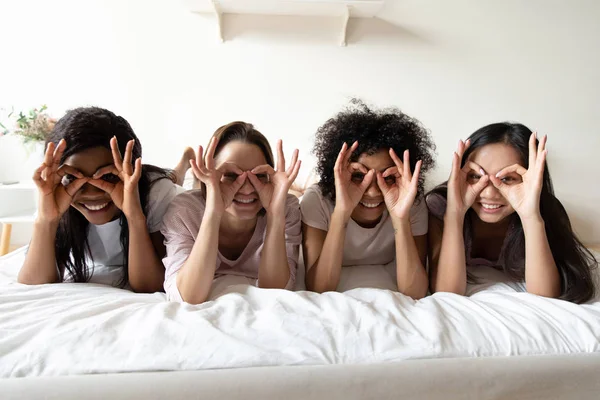 Gadis muda ceria multirasial bersenang-senang di tempat tidur di waktu istirahat — Stok Foto