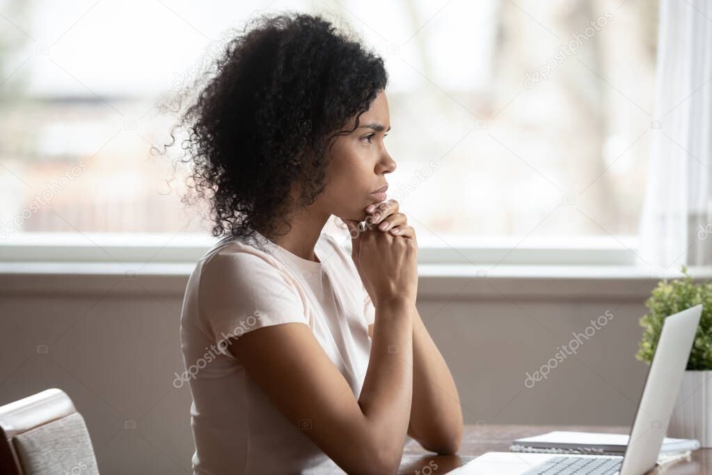 Pensive african American woman look in distance thinking