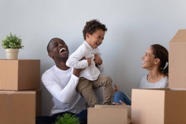 Happy laughing african american young man rising up joyful son. clipart