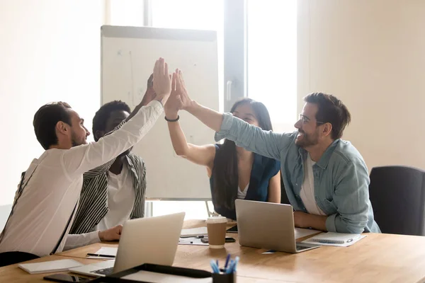 Multiethnic work team give high five motivated for shared success — Stock Photo, Image