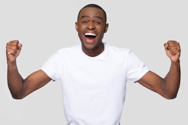 Mutlu gülümseyen Afrikalı Amerikalı adam başarıyı kutluyor.