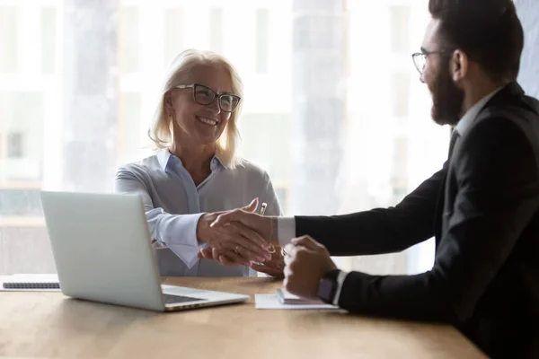 Smiling multiethnic businesspeople handshake greeting at meeting — Stock Photo, Image