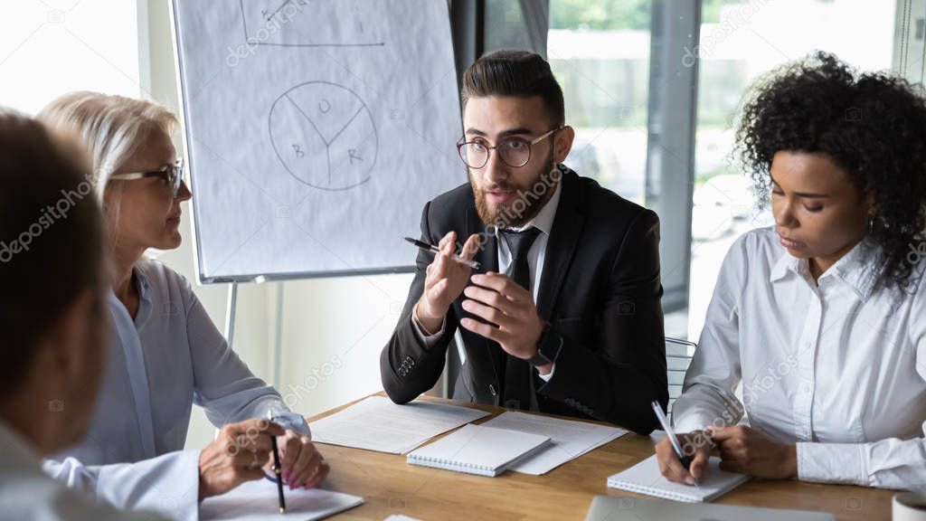 Focused Arabian boss talk discussing ideas with colleague at meeting