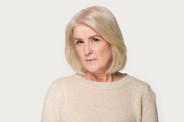 Head shot of angry old woman looking at camera