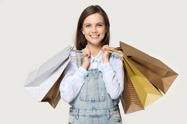Headshot of happy young woman holding paper packages in hands — Stock Photo, Image