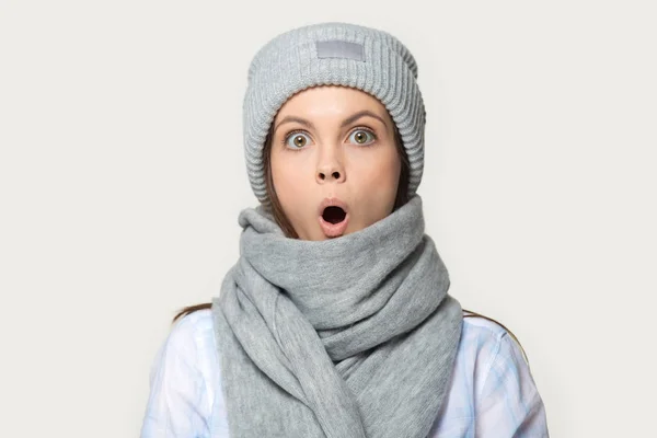 Headshot of surprised millennial woman wearing hat and scarf — Stock Photo, Image