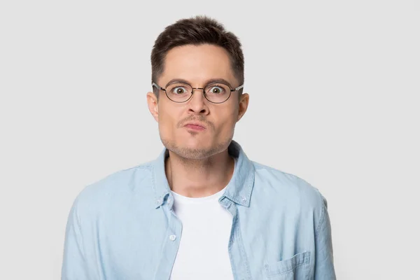 Headshot of confused angry man in eyeglasses looking at camera — Stock Photo, Image