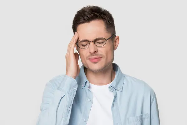 Nahaufnahme Kopfschuss eines jungen Mannes mit Kopfschmerzen Migräne — Stockfoto