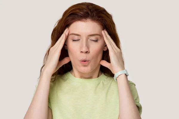 Young red-haired woman suffering from strong terrible headache. — Stock Photo, Image