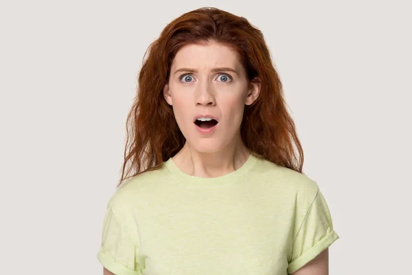 Studio portrait negatively surprised young red-haired woman. — Stock Photo, Image