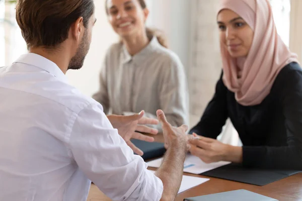 Konsentrert ung gruppeleder som forklarer markedsføringsstrategien for flerkulturelle kolleger . – stockfoto