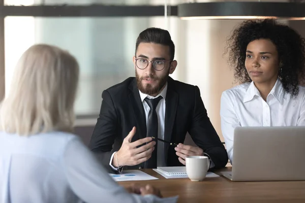 Diverse businesspeople talk discussing cooperation at office meeting — Stock Photo, Image