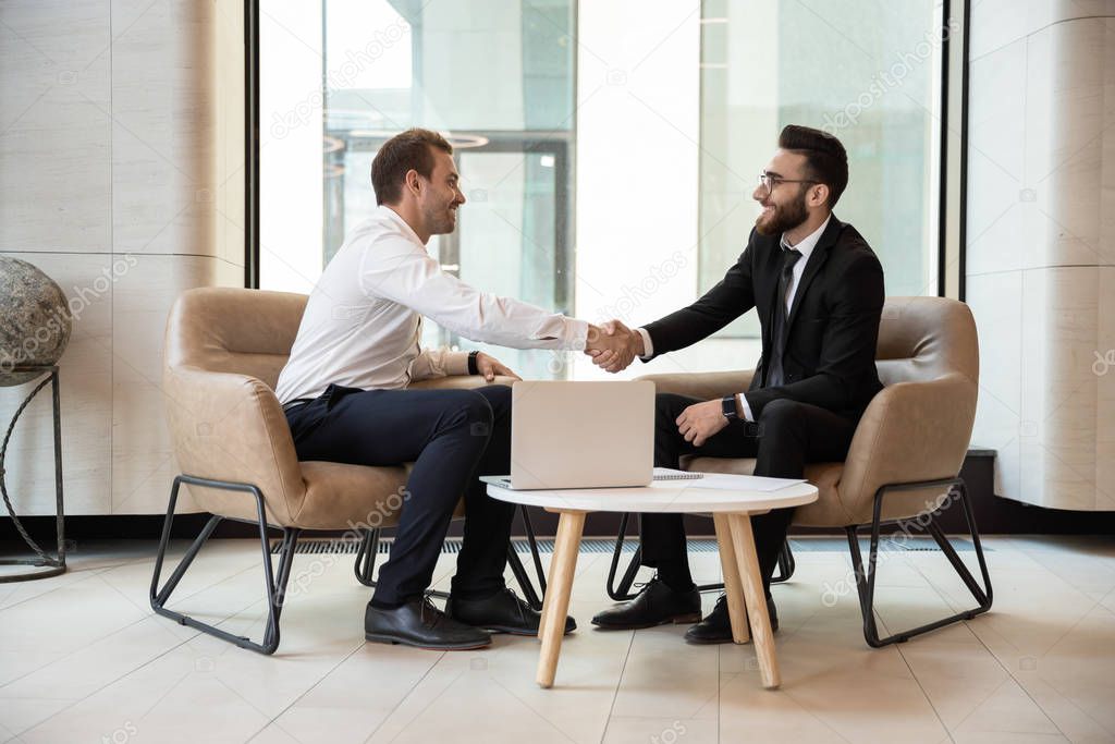 Multiracial businessmen handshake getting acquainted at meeting