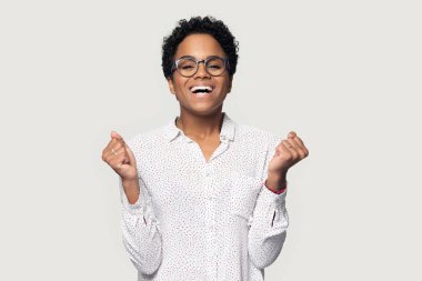 Smiling young african american woman celebrating business achievement.