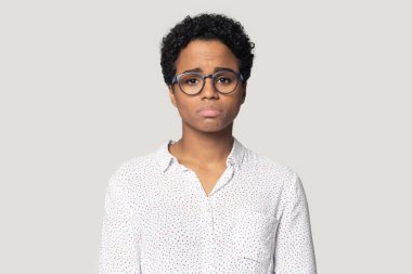 Upset unhappy millennial african american girl looking at camera.
