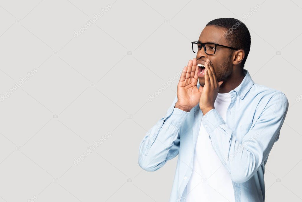 Emotional african american millennial guy shouting at copyspace.