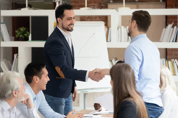 Multi racial businessmen shaking hands closing deal — Stock Photo, Image