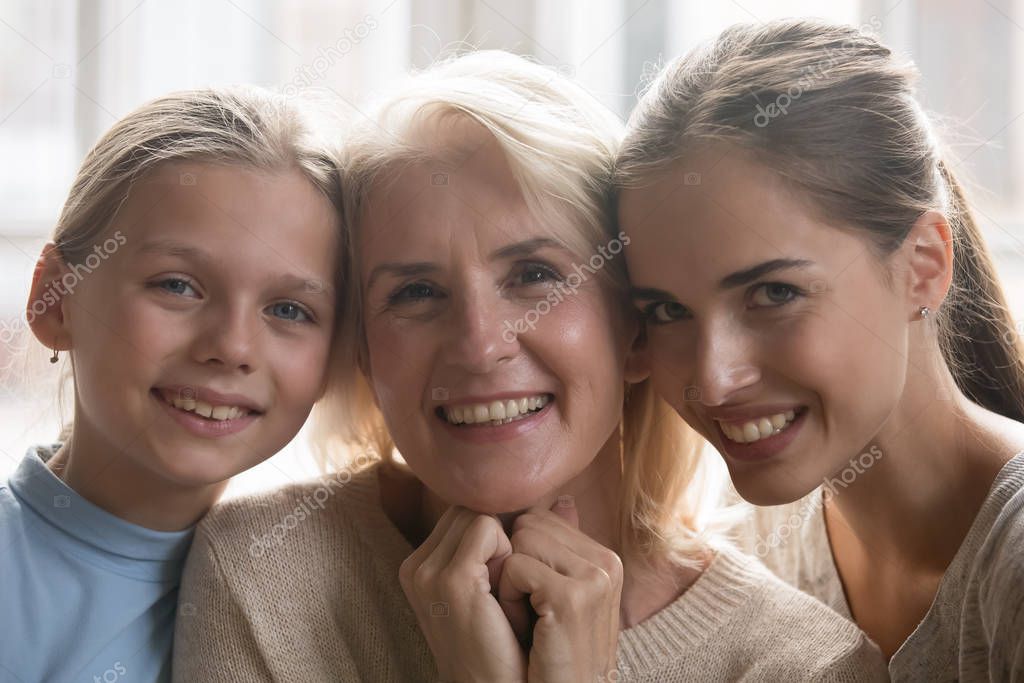 Portrait of three generations of women posing at home