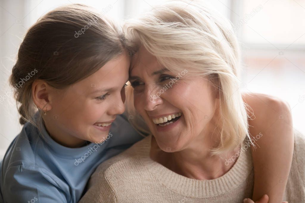 Loving granddaughter hug happy grandmother enjoying time together