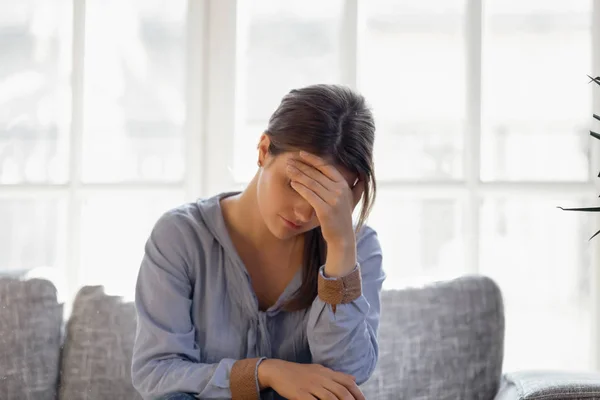 Upset young woman hiding face, crying, thinking about problem — Stock Photo, Image