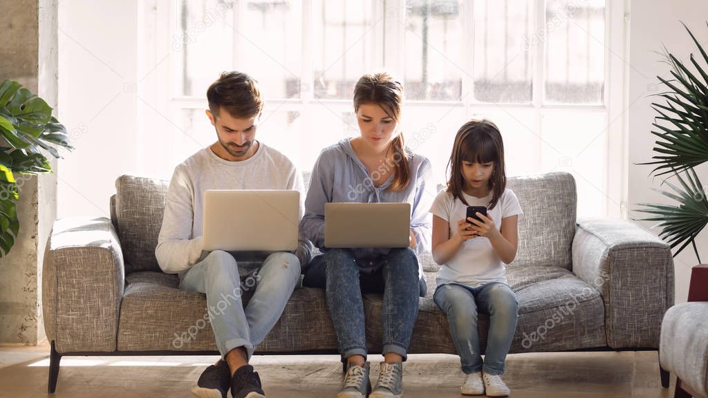 Family with daughter using laptops and smartphone, gadget addiction concept