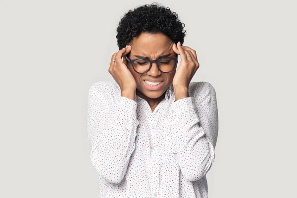 African unhealthy woman touch temples suffers from migraine studio shot — Stock Photo, Image