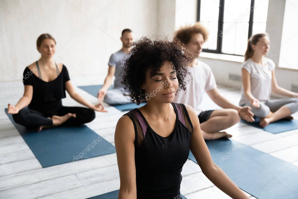 African American woman enjoying meditation, practicing yoga, Padmasana exercise