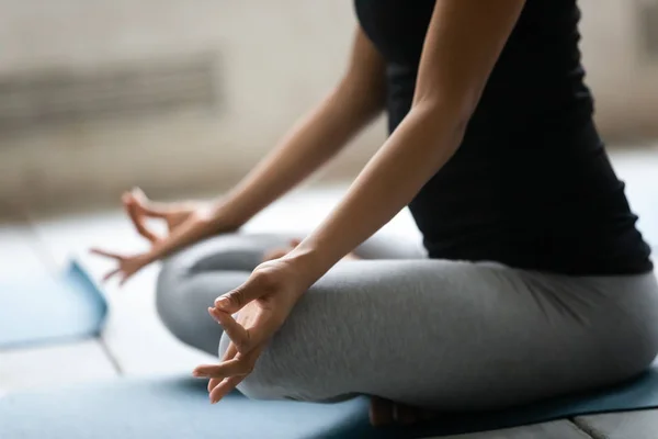 Close up African American woman doing Padmasana exercise, practicing yoga — Stock Photo, Image