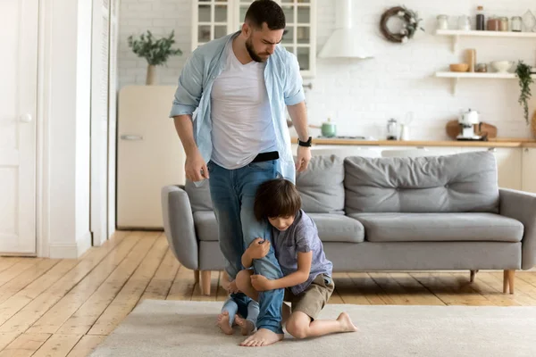 Father leaving while his children keep him not letting go — Stock Photo, Image