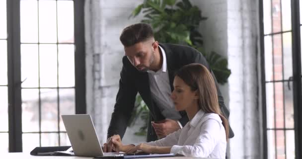 Female intern learning computer software talking to mentor in office — 비디오