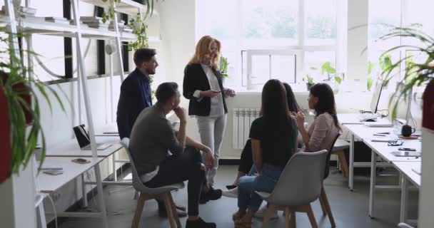 Happy mature female mentor communicating with multiracial business team — Stock Video