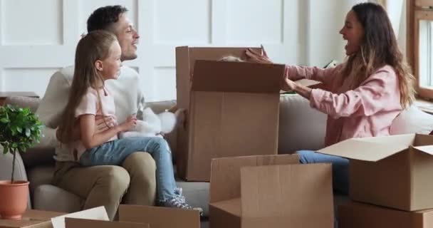 Cute kid daughter jumping out of box on moving day — 비디오