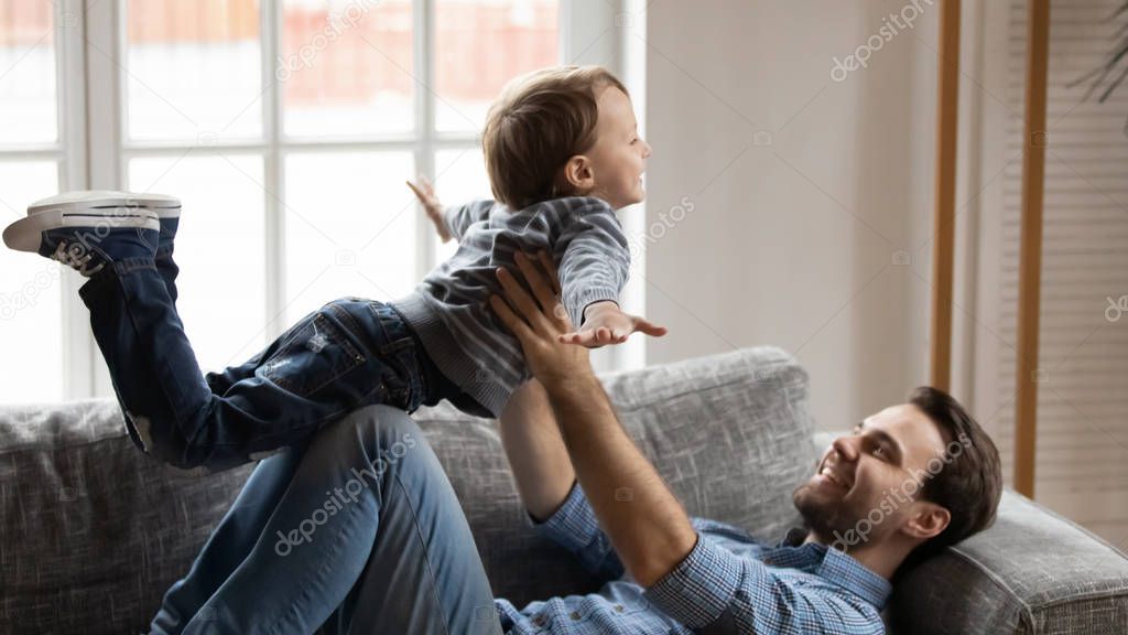 Young dad play have fun with small excited son
