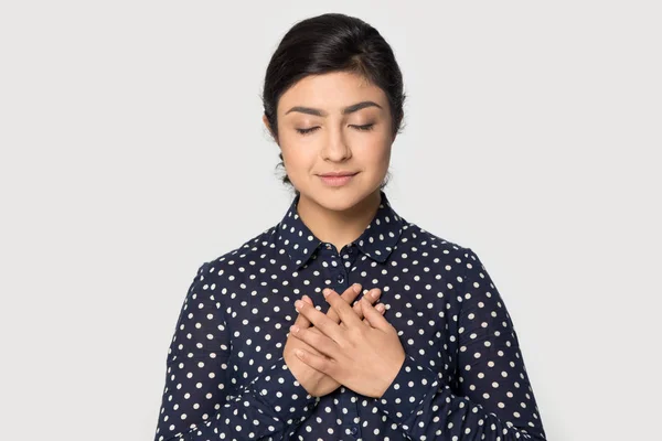 Grateful young attractive indian girl folding hands on chest. — Stock Photo, Image