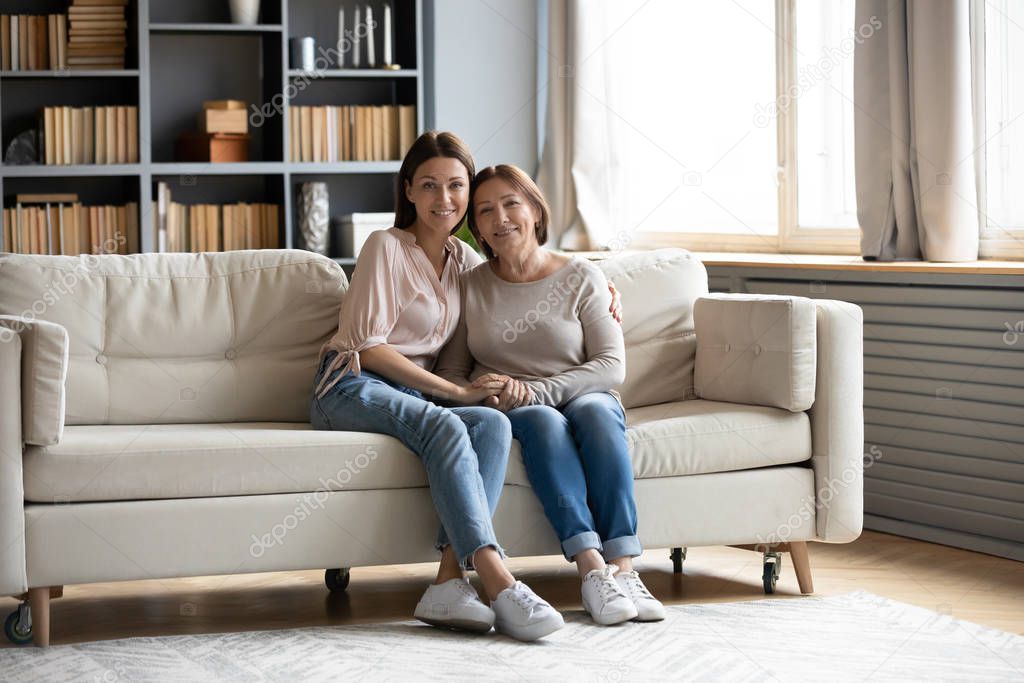 Portrait of happy senior mom and adult daughter