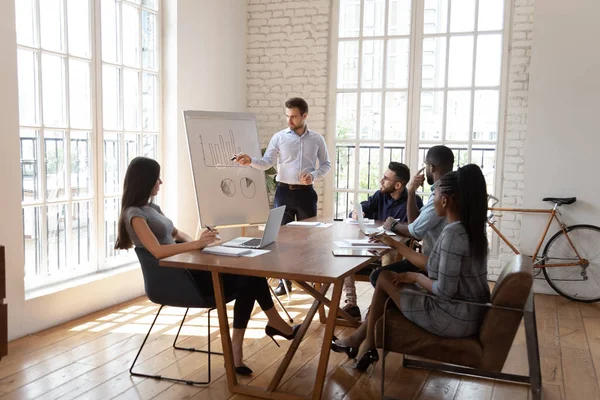 Male coach make whiteboard office presentation to diverse employees — ストック写真