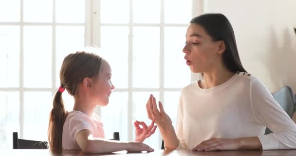 Заботливая мама логопед обучение дошкольница девочка правильное произношение — стоковое видео