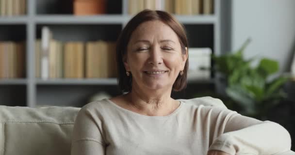 Sorrindo senhora idosa olhando para a câmera posando em casa — Vídeo de Stock