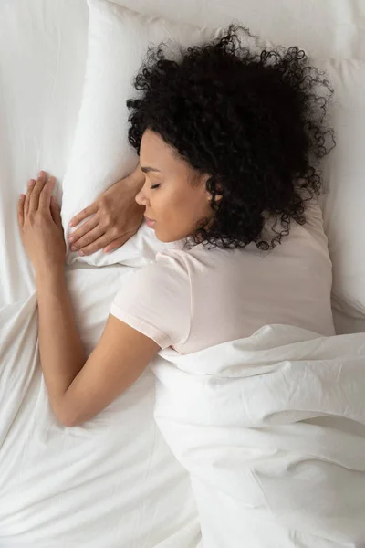 Above top vertical view african woman sleeping in bed