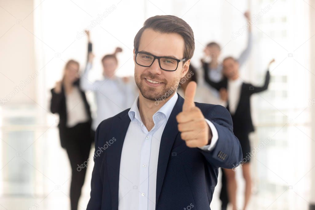 Portrait of smiling businessman show thumb up recommending service