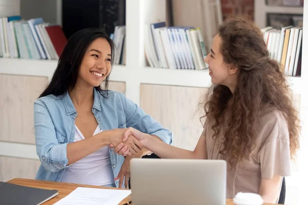 Smiling girls handshake in office getting acquainted — ストック写真