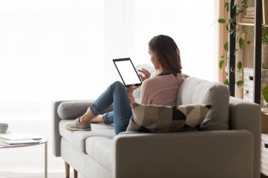 Elinde tablet tutan genç bir kadın..