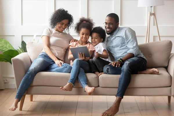 Happy african american family using tablet together. — Stok Foto