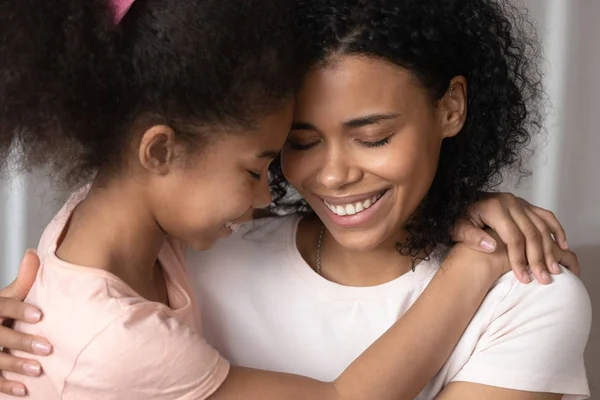 Onnellinen musta nuori nainen halaus adoptoitu lapsi . — kuvapankkivalokuva