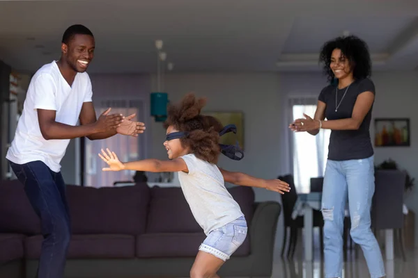 Little girl have fun with parents playing hide and seek — Stock Photo, Image