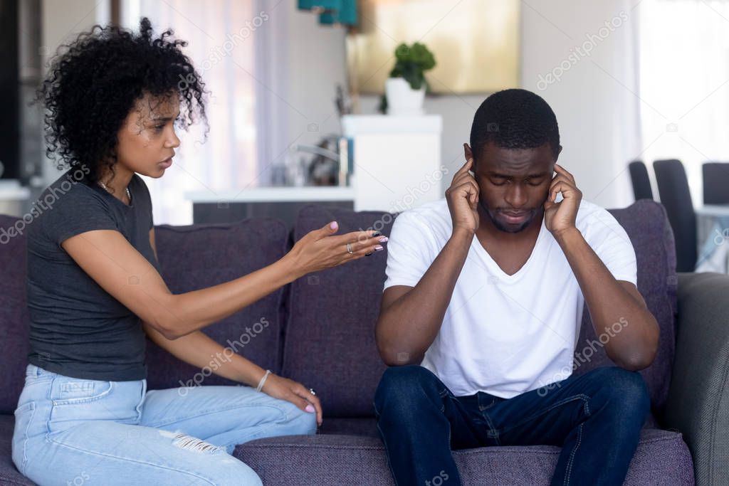 Indifferent black husband ignore pushy wife lecturing