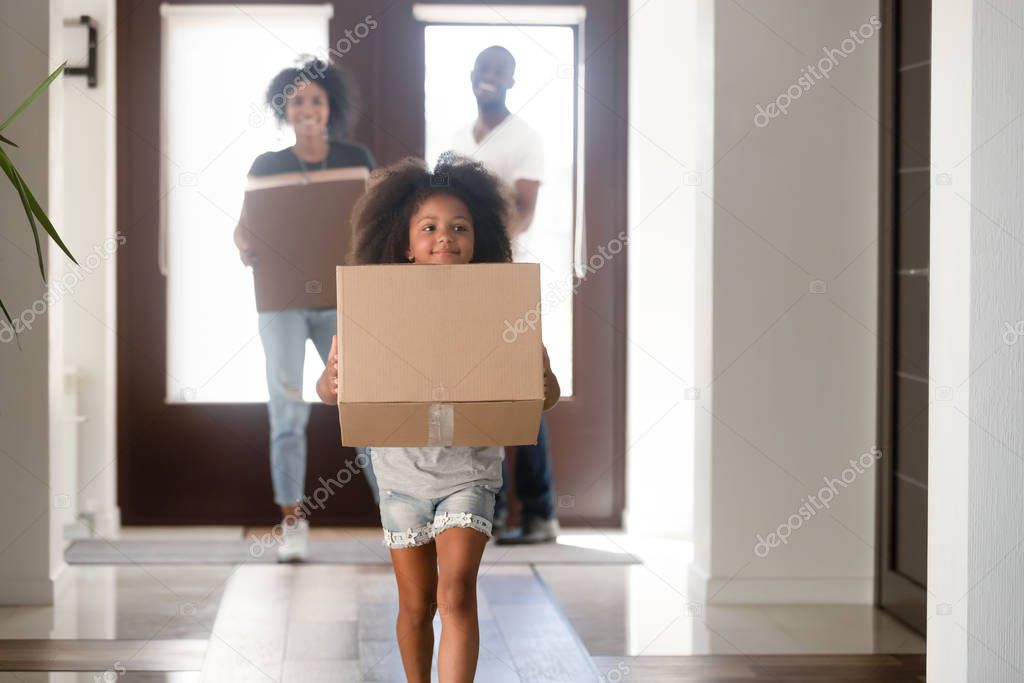 Young family carry boxes moving to new home